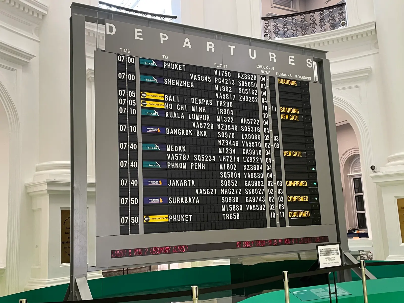 A split-flap departures board listing Asian destinations, several of them visa-free for Paraguayan passport holders