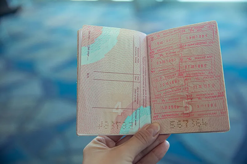 A passport and travel documents illustrating Paraguay residency and mobility for Ghanaians
