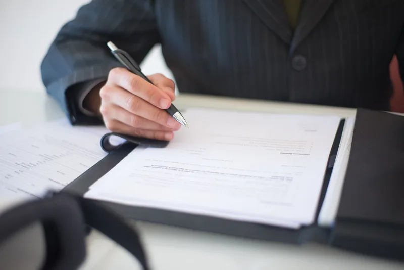 Documents and passport laid out for a Paraguay tourist visa application at a consulate