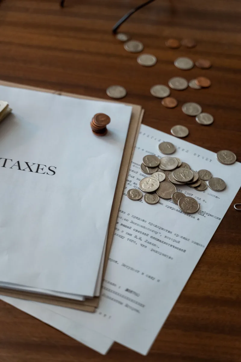 Tax documents and coins illustrating property tax in Paraguay